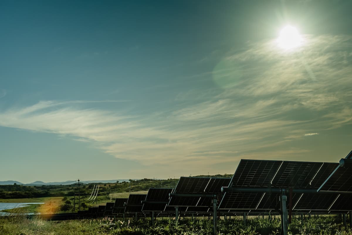 back of solar panels in the countryside at dusk