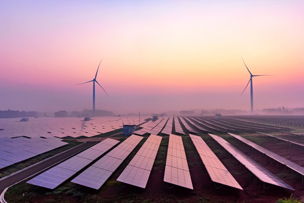 solar panels and wind turbines sunrise