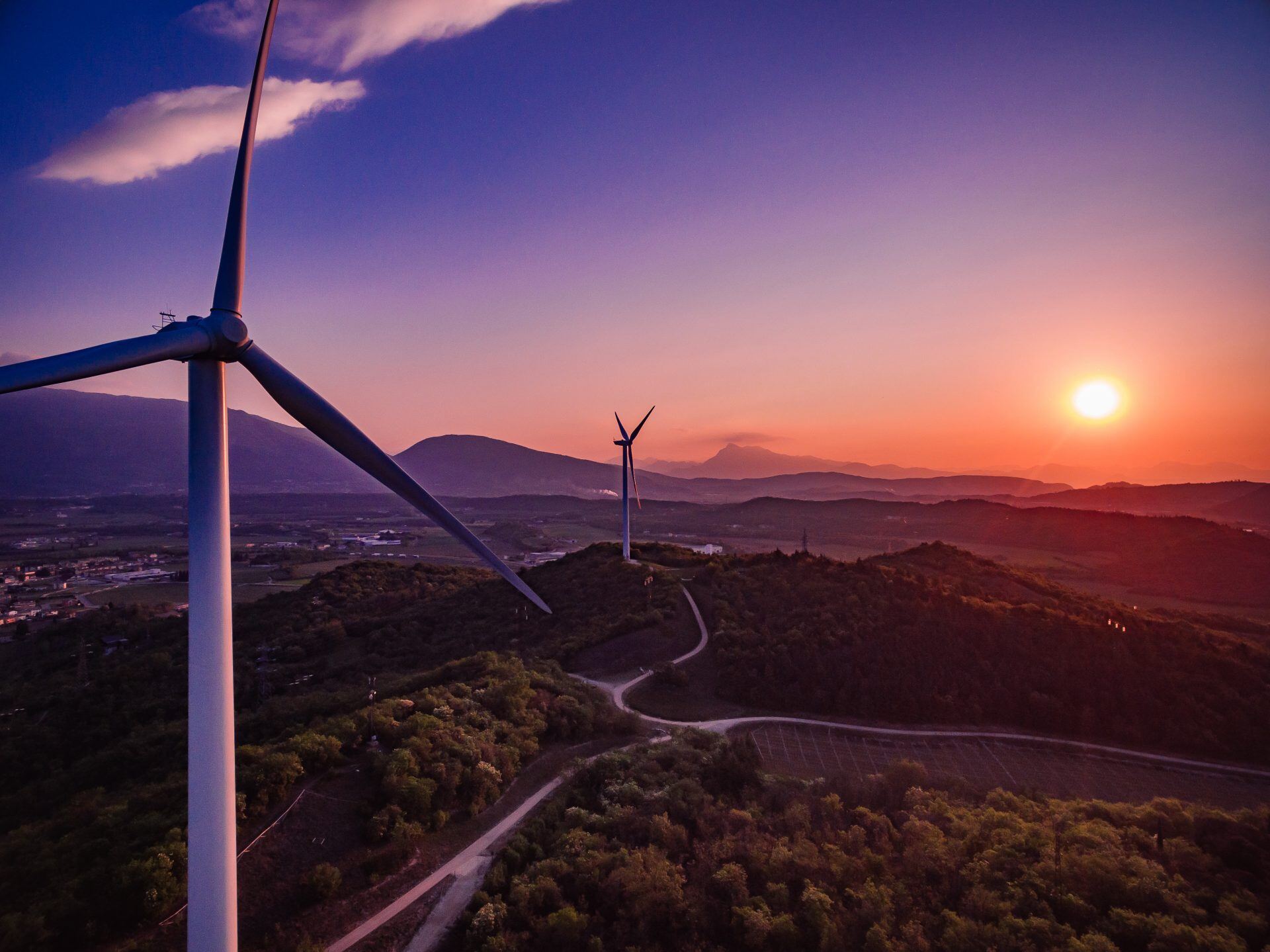 wind-turbines-windmill-energy-farm-at-sunset-in-it-2MLX3BD
